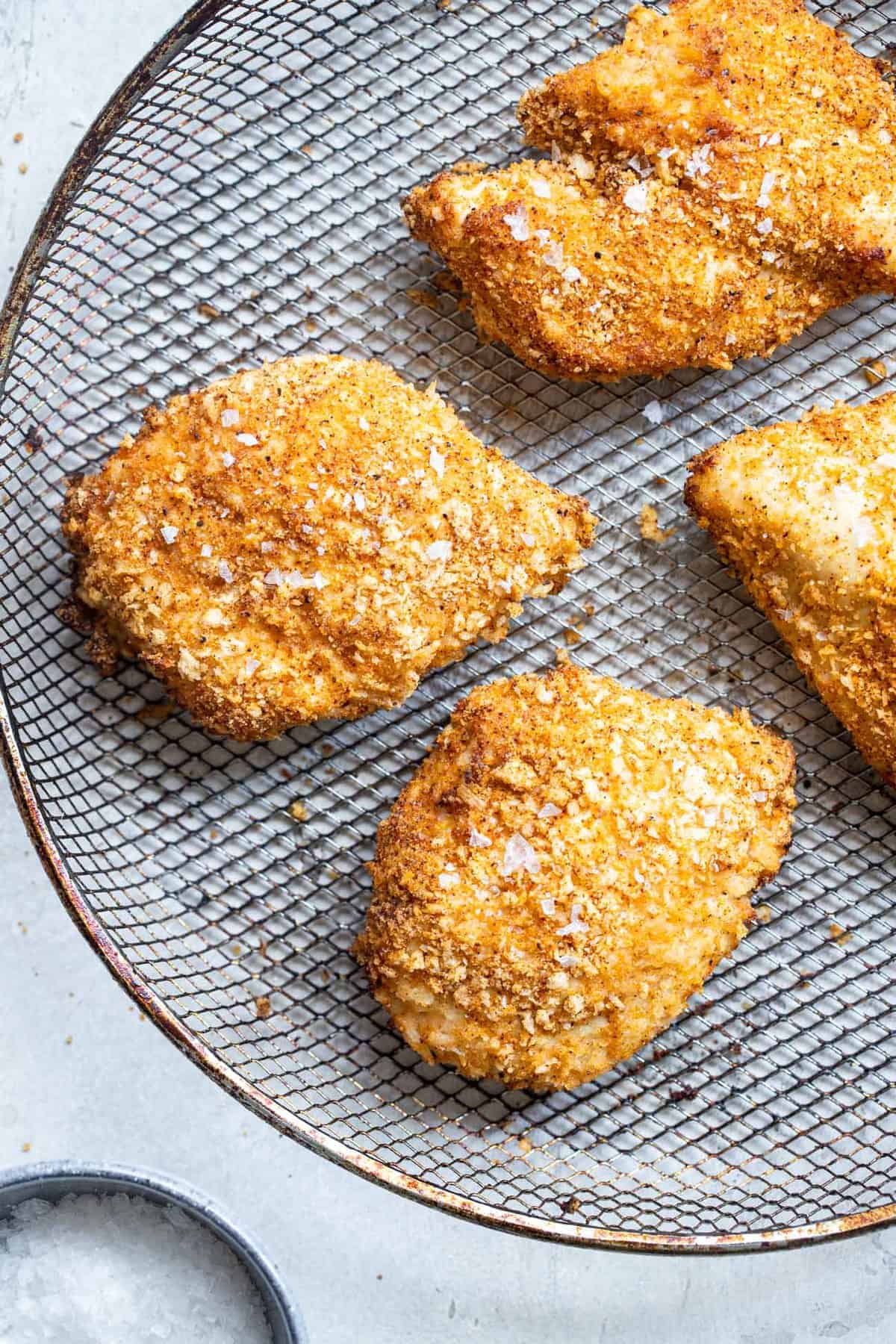 chicken breast in the air fryer cooked on a basket