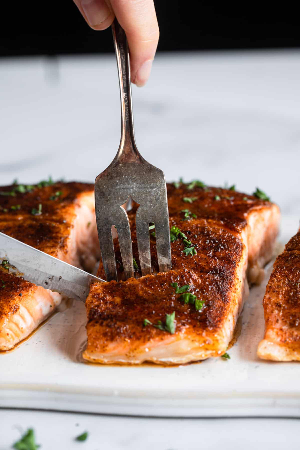 Honey Cajun Salmon being cut into with knife and fork