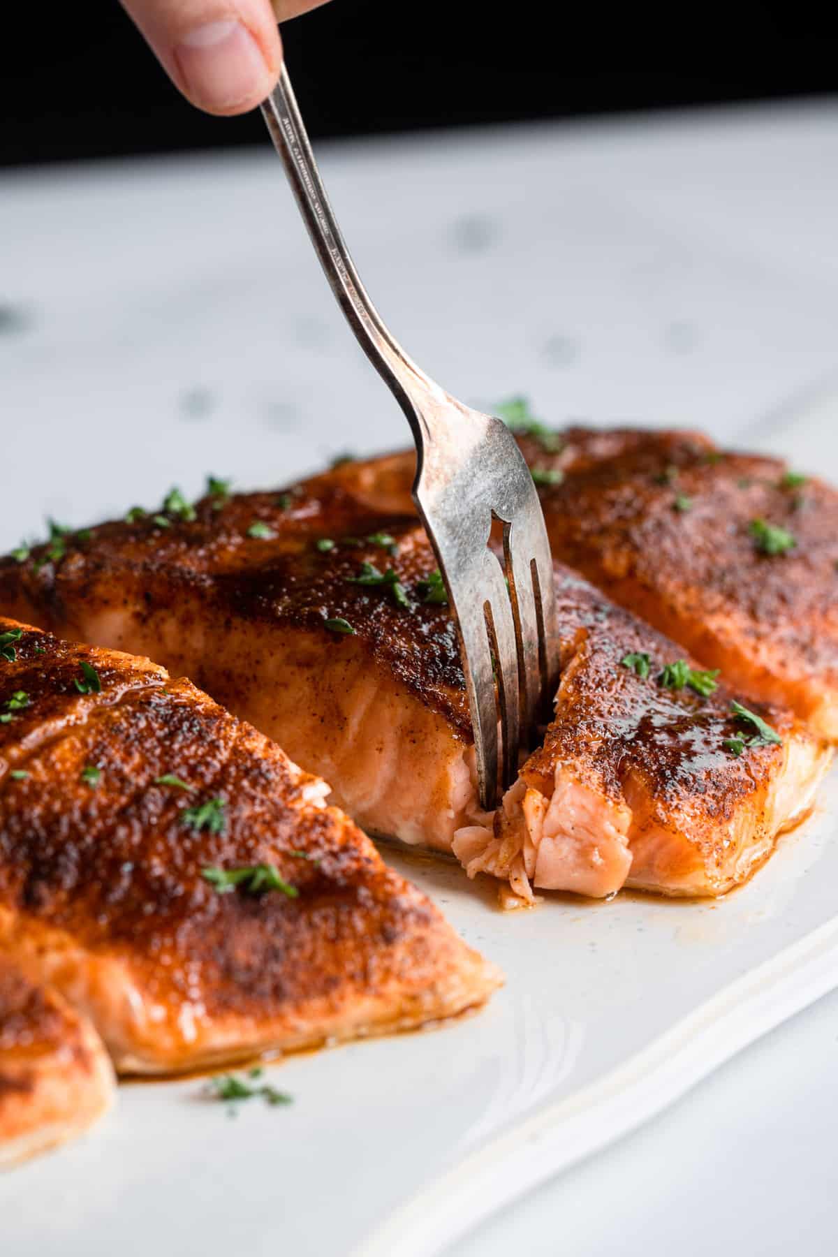 Honey Cajun Salmon being cut into with a fork