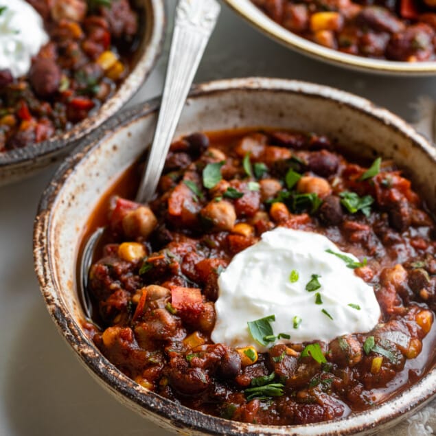 several bowls of Crockpot Vegetarian Chili with spoons