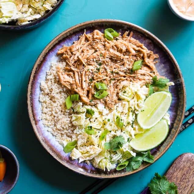 Slow Cooker Thai Peanut Chicken Quinoa Bowls - CREAMY crockpot Thai peanut chicken is mixed with quinoa and a spicy cabbage slaw to make a family friendly, gluten free and healthy meal! The slow cooker does the work for you! | #Foodfaithfitness | #Glutenfree #Dairyfree #Healthy #Slowcooker #Crockpot