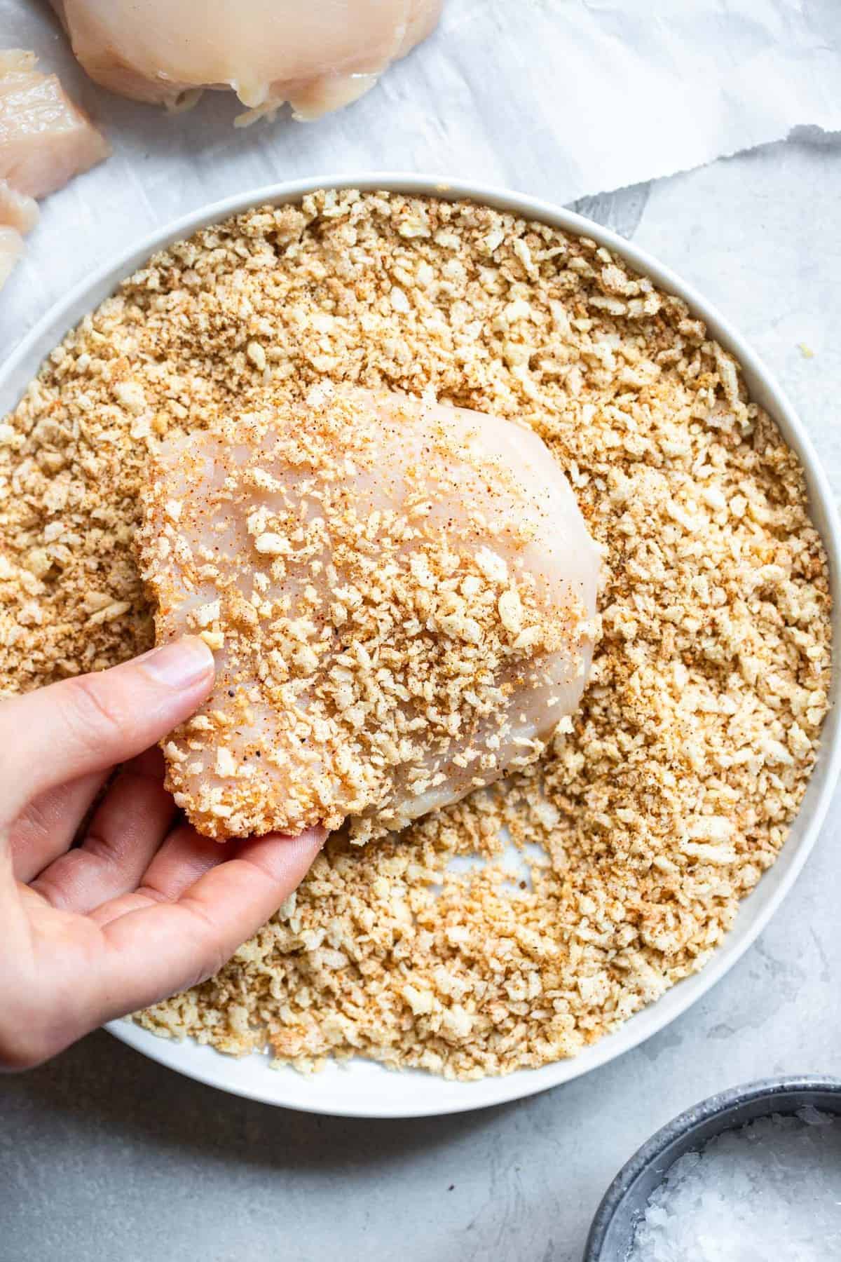 Air Fryer Breaded Chicken Breast being breaded