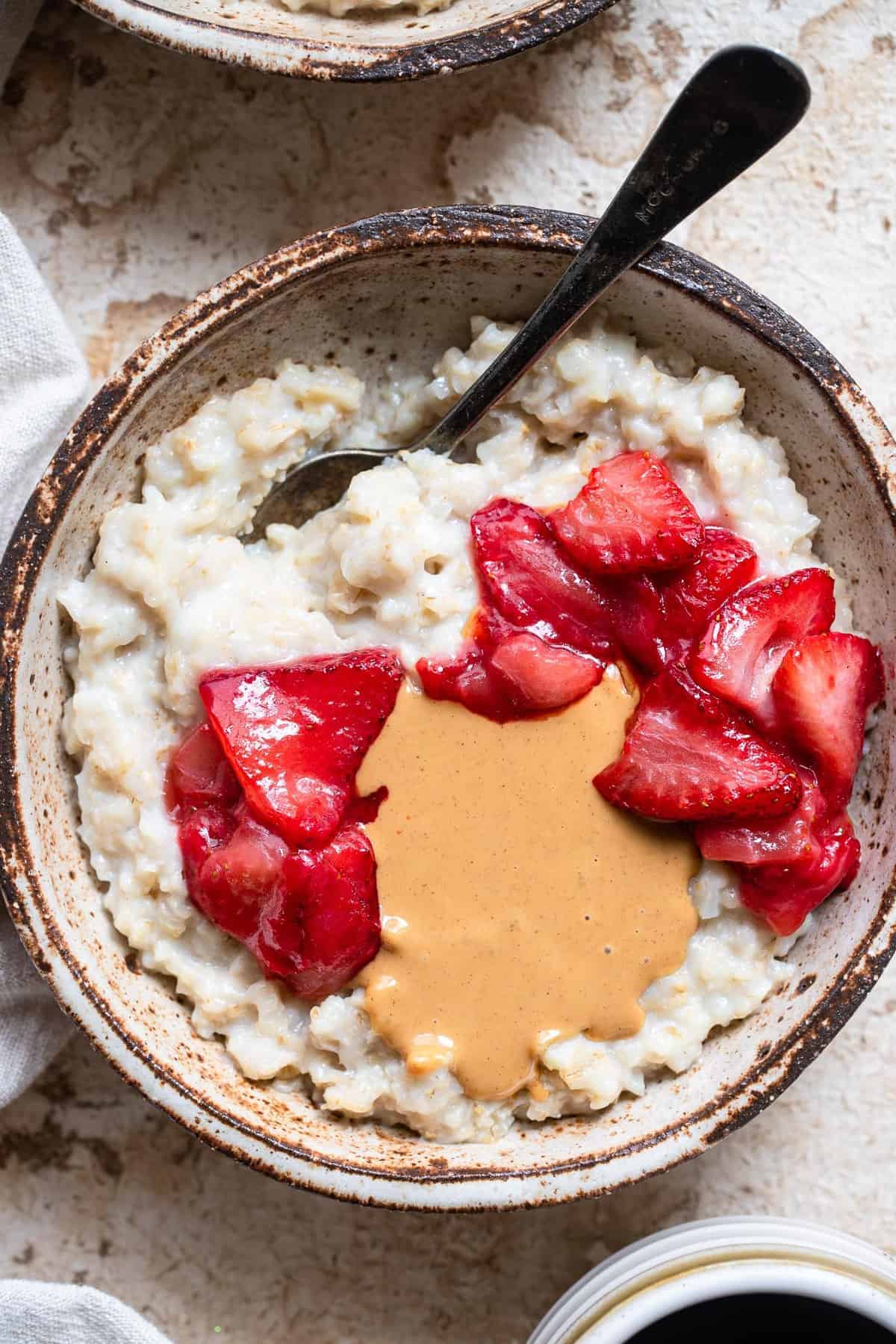 close up of cauliflower protein oats with toppings in bowl