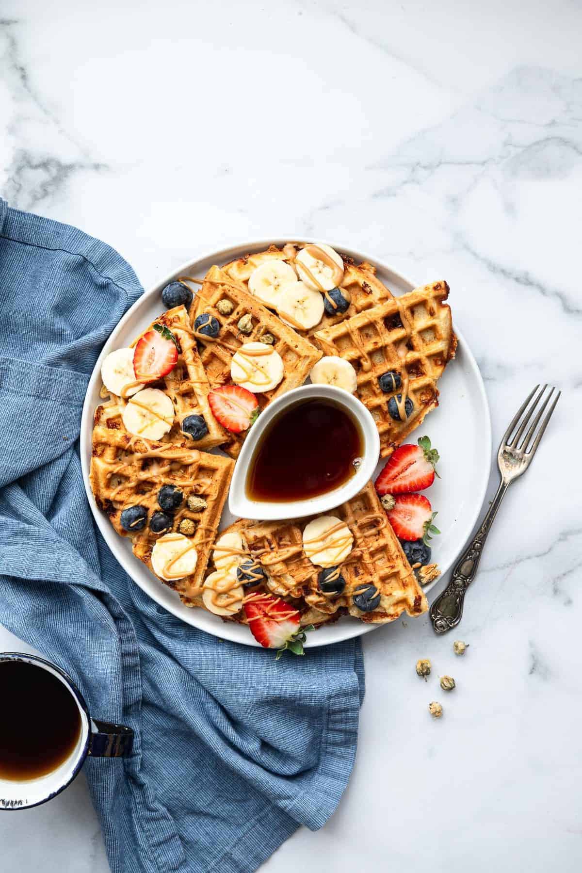 protein waffles on a plate with fruit on top