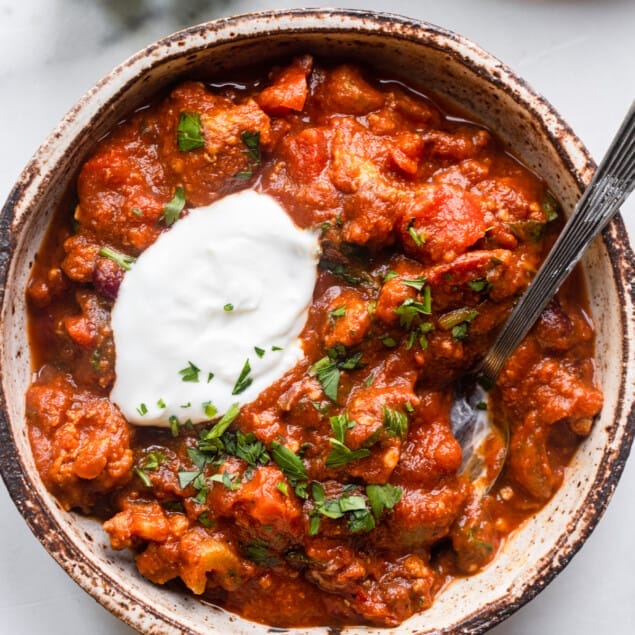 one bowl of Turkey Pumpkin Chili with a spoon and toppings